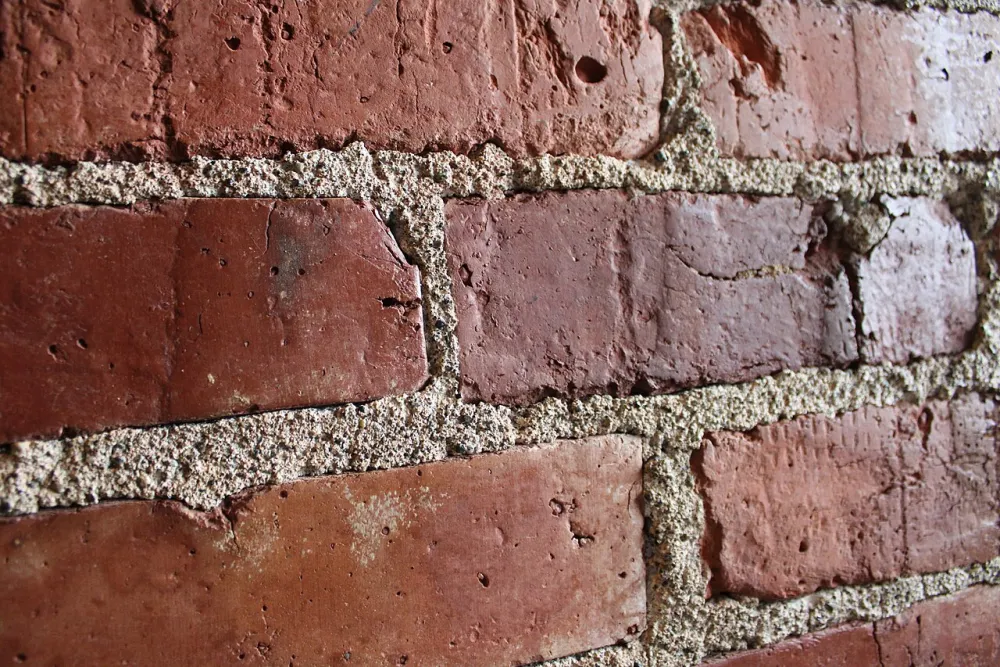 Close-up of a clean brick wall laid in a regular bond pattern with even mortar joints